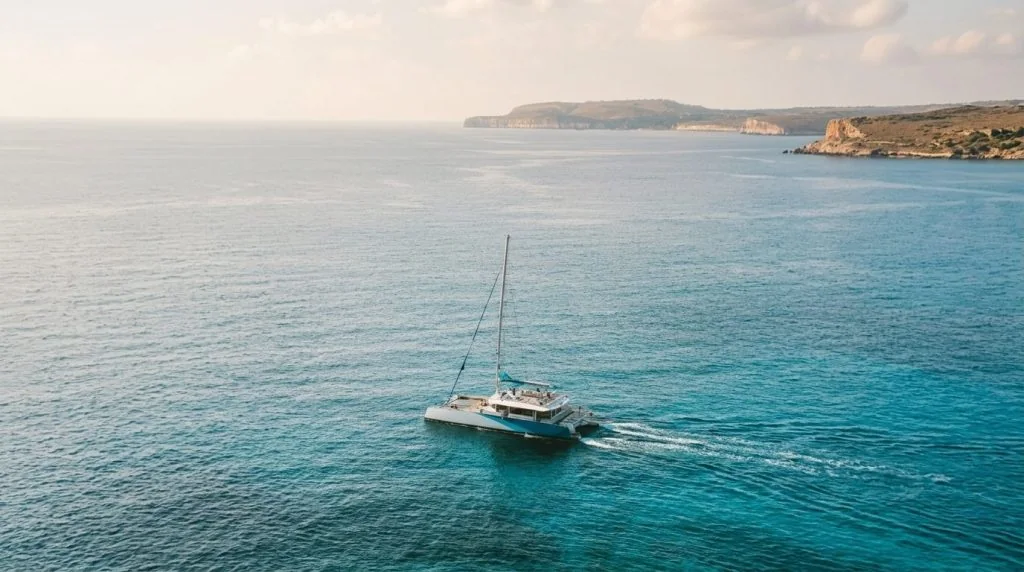 A sailing catamaran cruising off the Mallorca coast